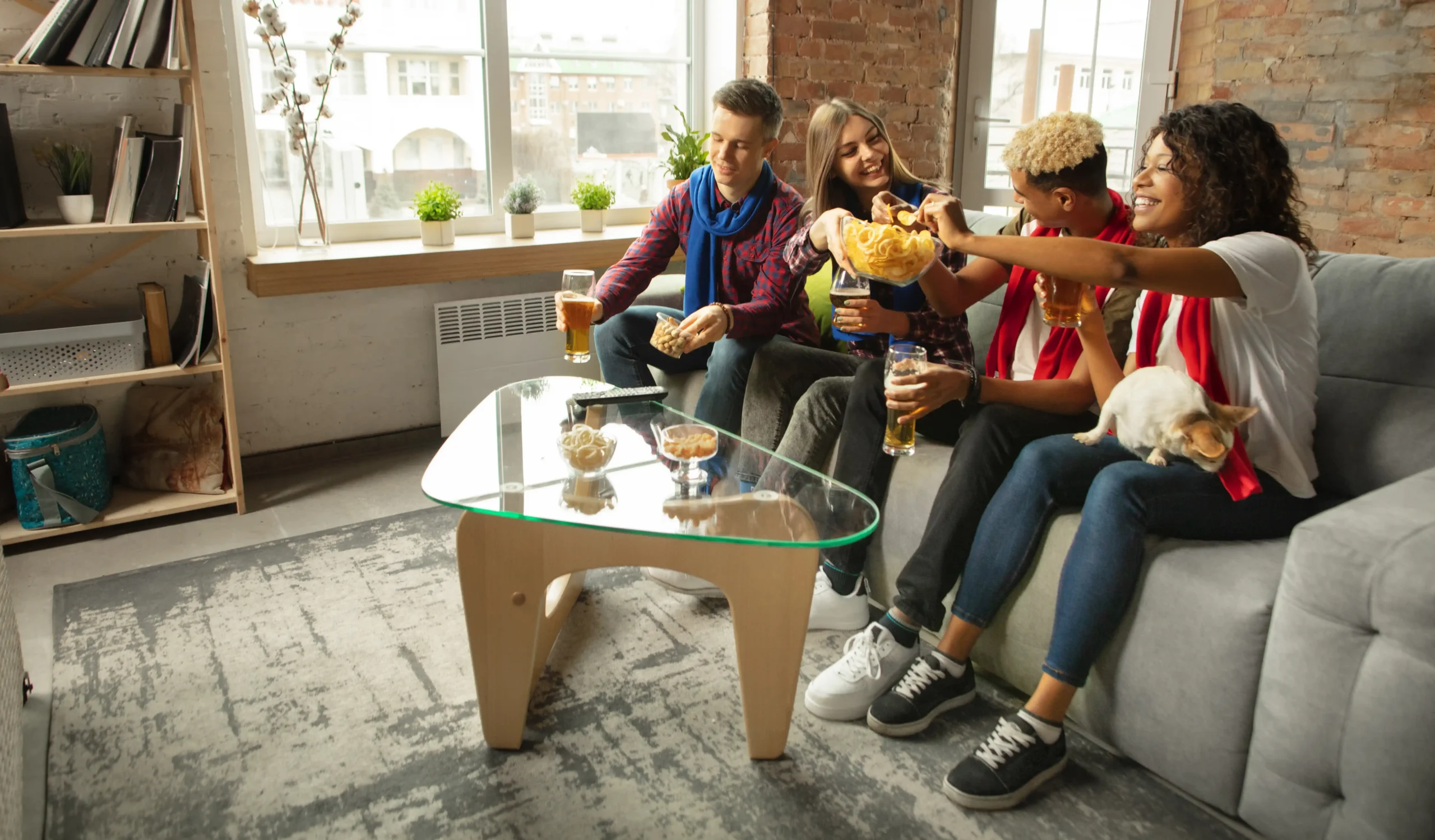 Friends enjoying snacks and drinks together in apartment