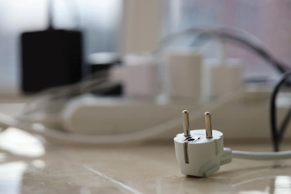 smart doorbell comparison and Overloaded power boards. Power strips with different electrical plugs on white floor